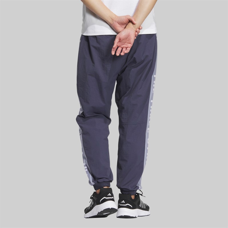 adidas Spodnie dresowe o luźnym kroju z napisem dla niego kolor Shadow Navy