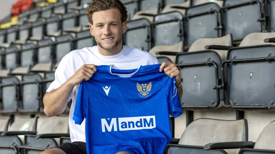 St Johnstone player Jamie Gullan with the 25/26 home jersey.