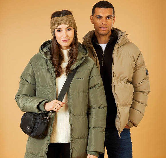 Smart young couple wearing puffer jackets.