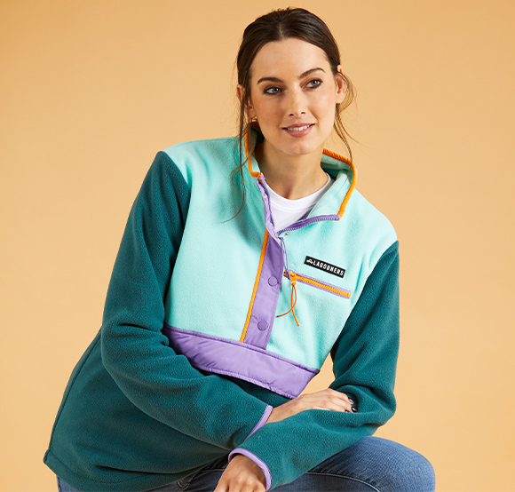 Female wearing a colourful green fleece top.