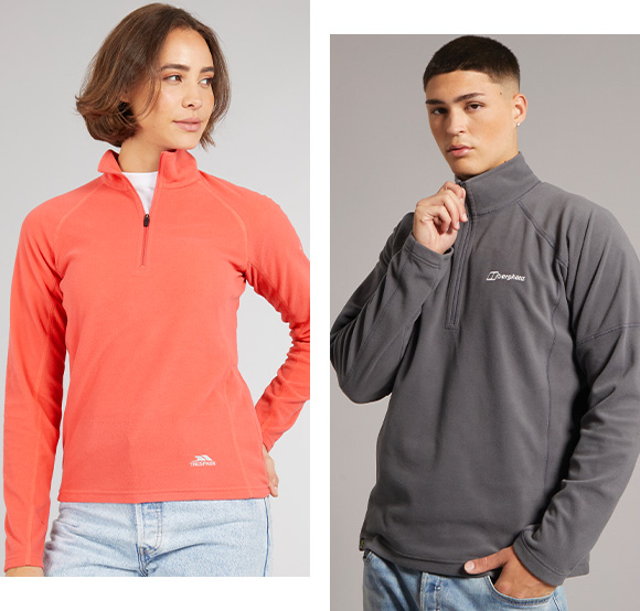 Woman in coral Trespass 1/4 zip fleece top and man in dark grey Berghaus 1/4 zip fleece top.